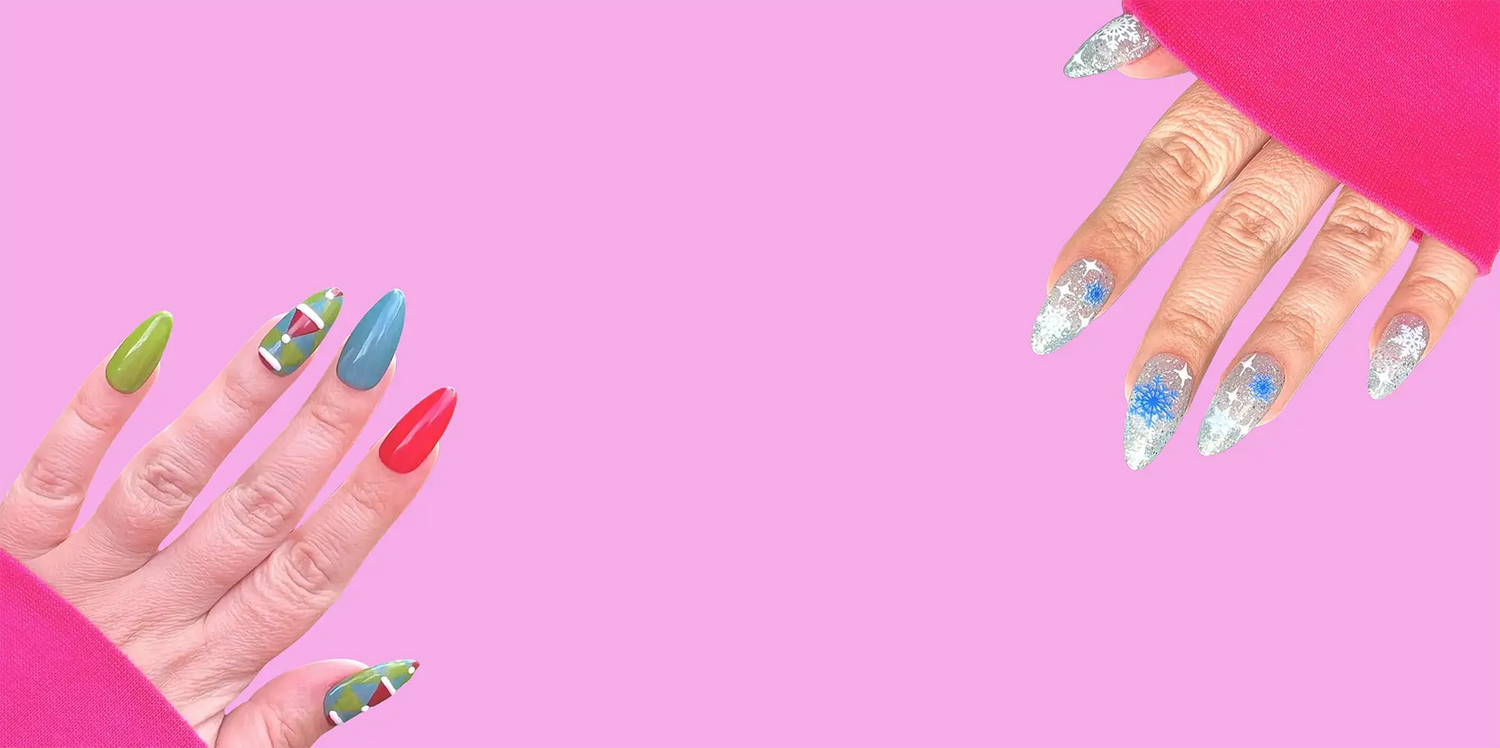 Two hands showcasing vibrant nail designs; one with colorful geometric patterns and solid shades, the other with sparkling silver and blue snowflake details against a pink background.